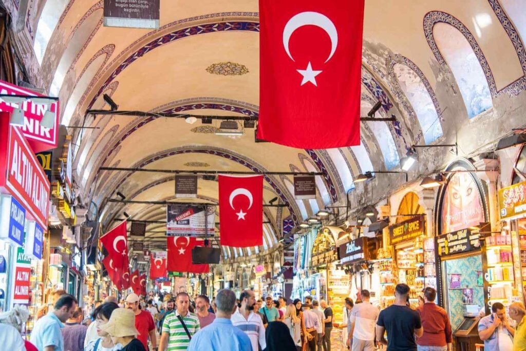 Interior view of Istanbul's Grand Bazaar showcasing vibrant shops, colorful goods, and arched ceilings.